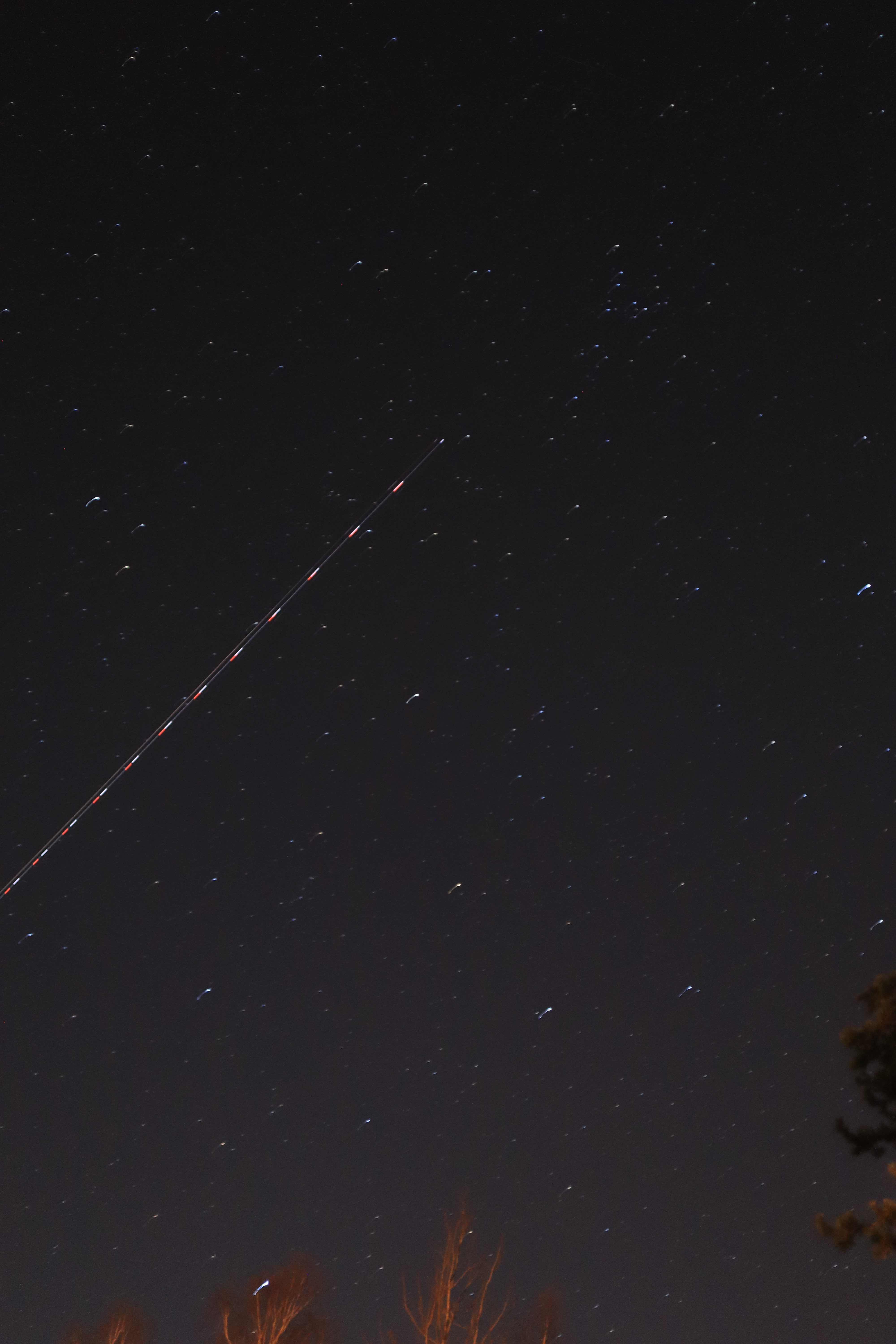 plane trail in the night sky